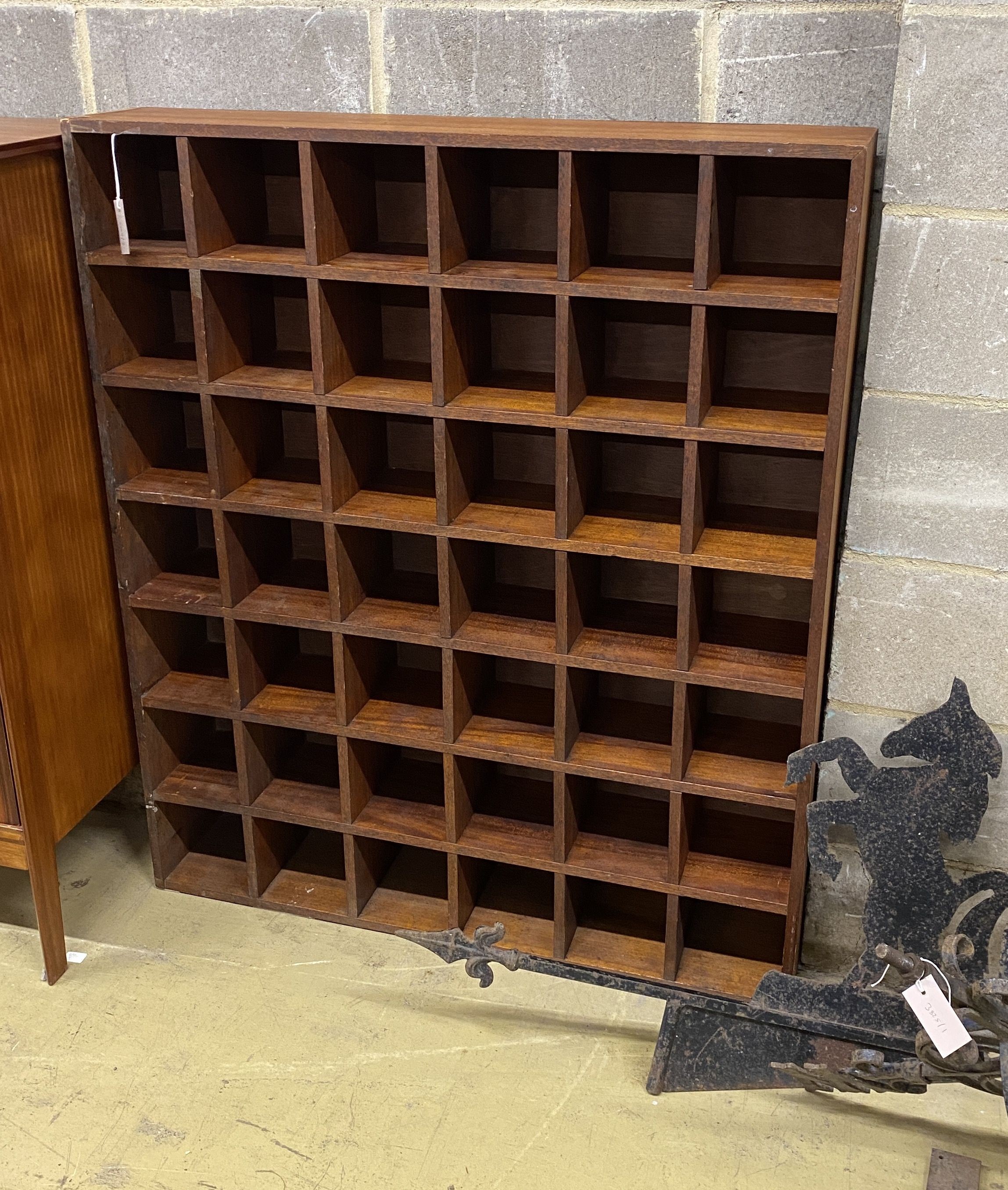 A mahogany pigeonhole wall unit, width 104cm, depth 21cm, height 122cm